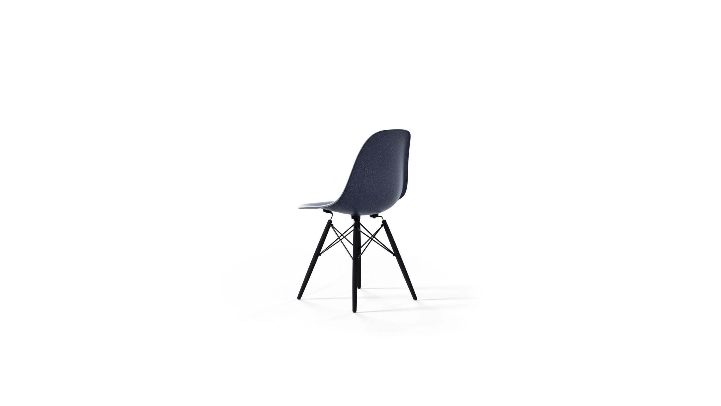 Back-Angle view of the molded Fiberglass Side Chair: Dowel Base DFSW by Charles and Ray Eames, designed by Charles and Ray Eames, available online in Canada. Made by Archetype Forms.