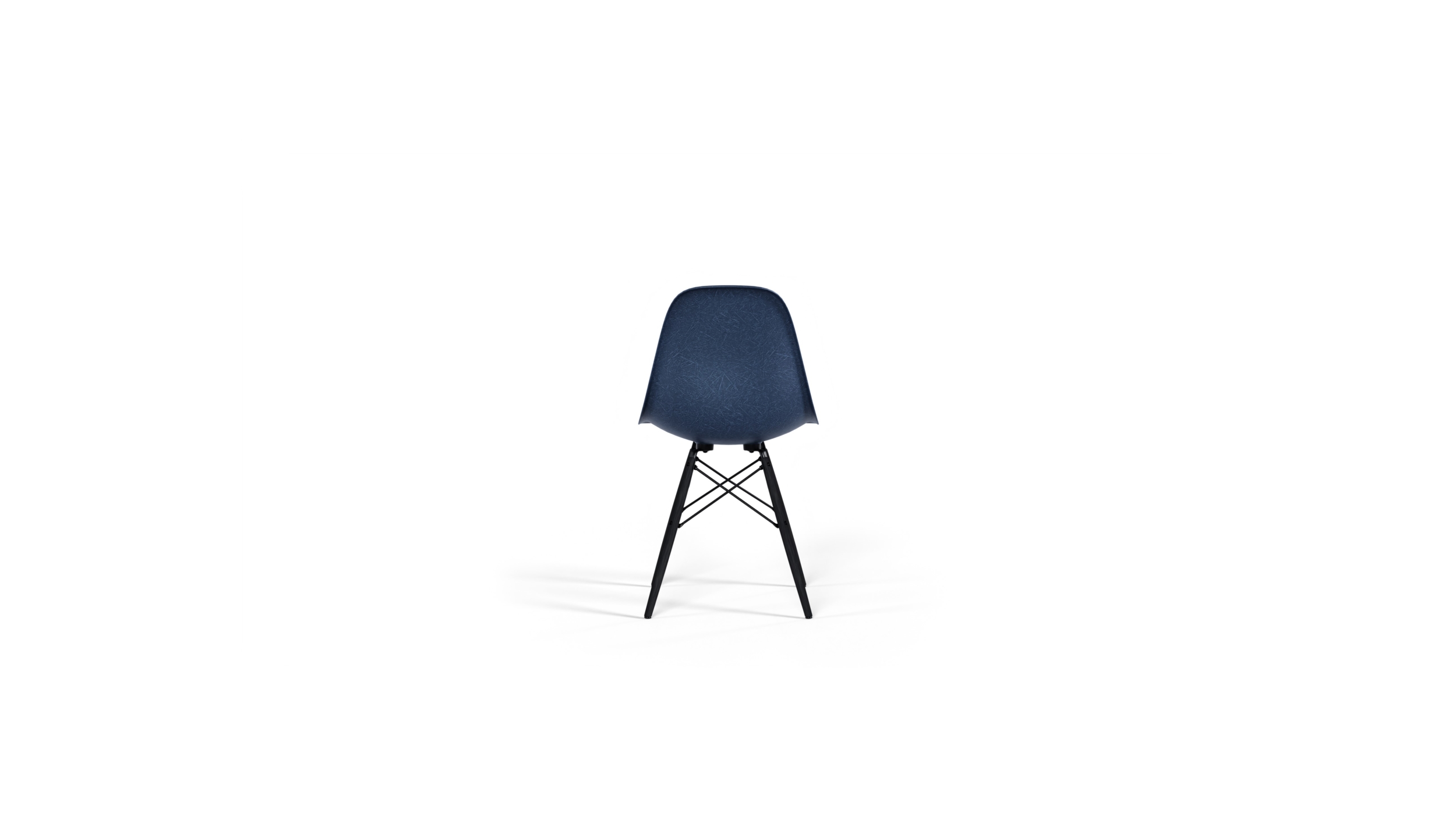 Back view of the molded Fiberglass Side Chair: Dowel Base DFSW by Charles and Ray Eames, designed by Charles and Ray Eames, available online in Canada. Made by Archetype Forms.