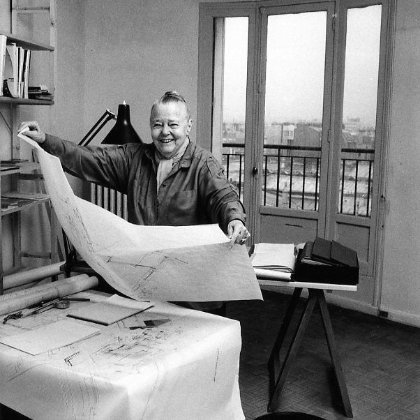 Royalty Free image or Furniture Designer Charlotte Perriand in a room with furniture design plans