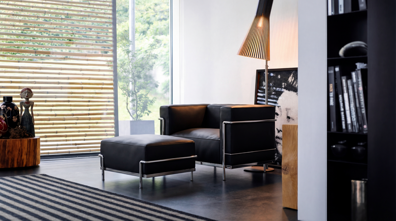Le Corbusier LC3 down feather Armchair reproduction with a LC2 | LC3 Ottoman in a modern sitting room - USA Hero Image