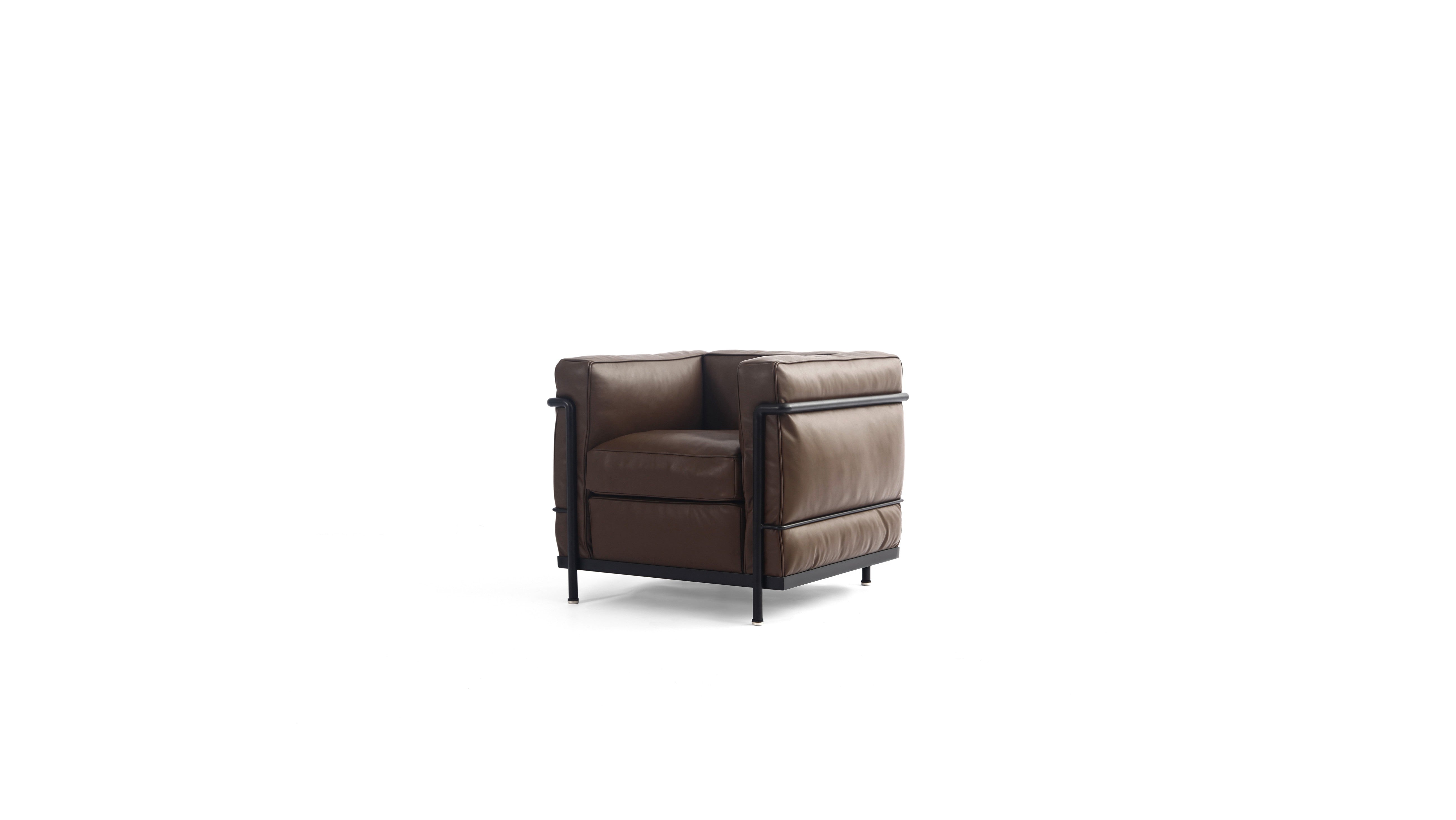 A modern brown leather LC2 armchair with a black metal frame and legs, shown from a quarter angle on a solid white background.