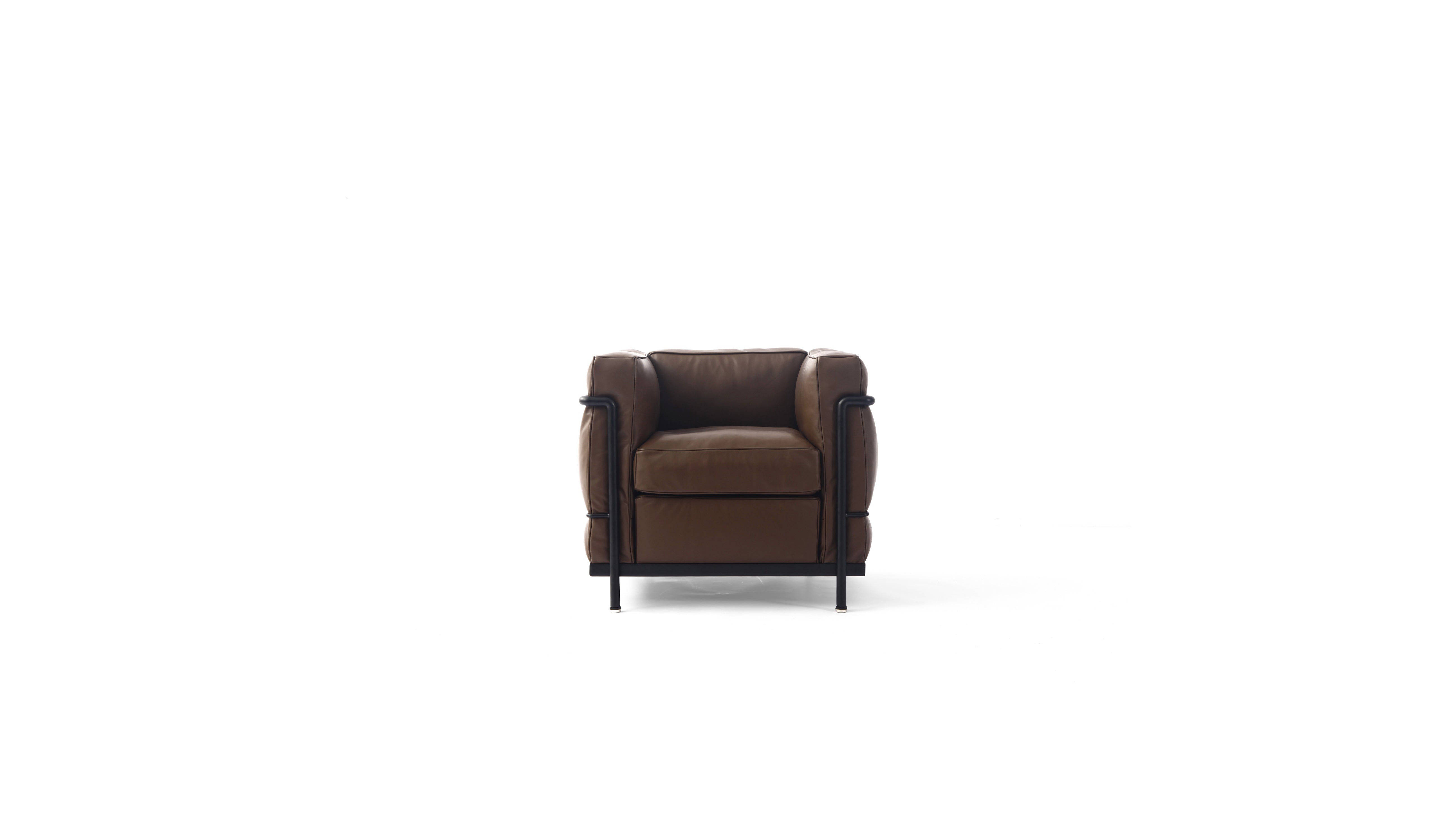 A modern brown leather LC2 armchair with a black metal frame and legs, shown from a front angle on a solid white background.