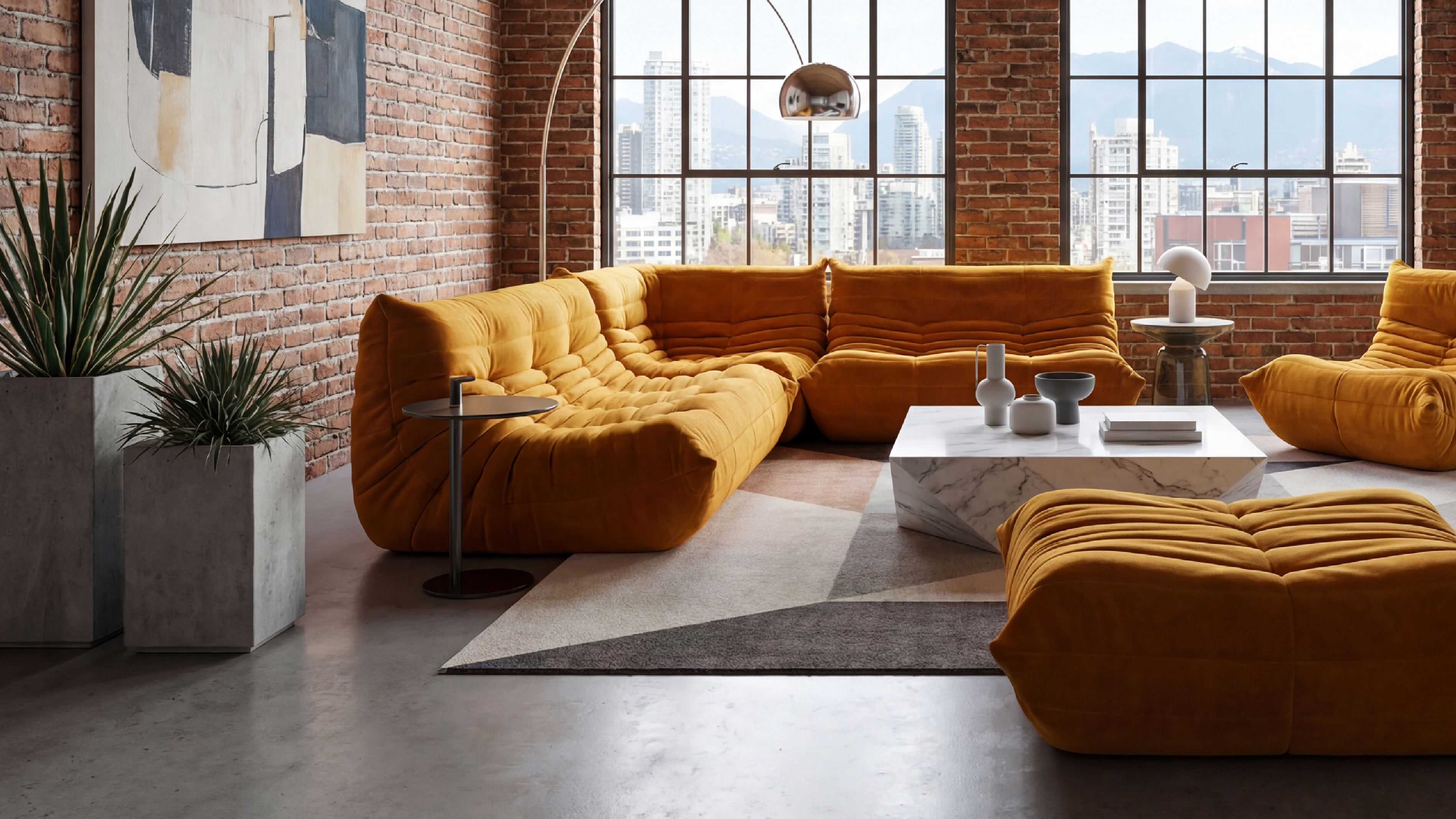 Modern living room with yellow velvet Michel Ducaroy TOGO Sofa 3-Seater without Arms model r-3232 repro sectional sofa, coffee table, and cityscape view. Desktop Hero