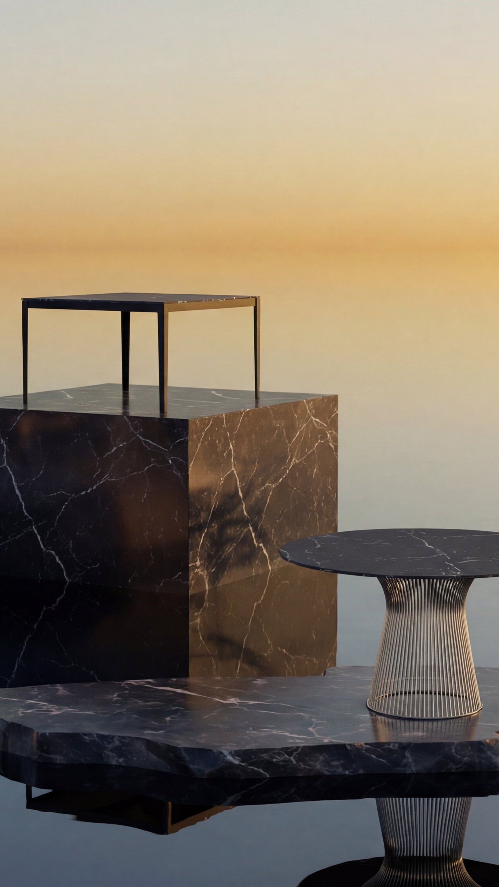 Set of marble and glass dining tables with a gradient sky background - Mobile Hero Image