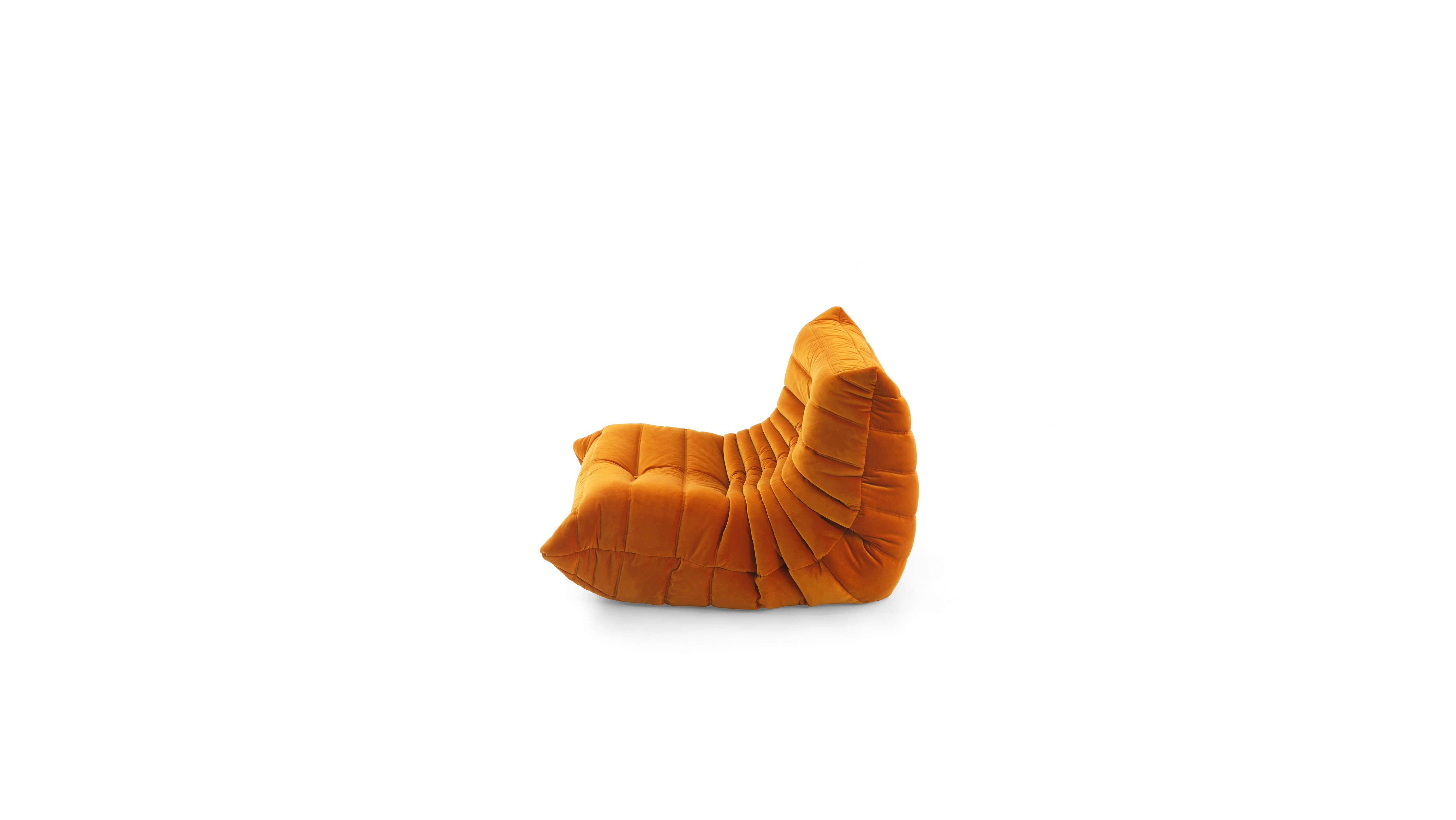 An orange TOGO Fireside Chair module with a pleated, segmented design, shown from a side profile on a solid white background.